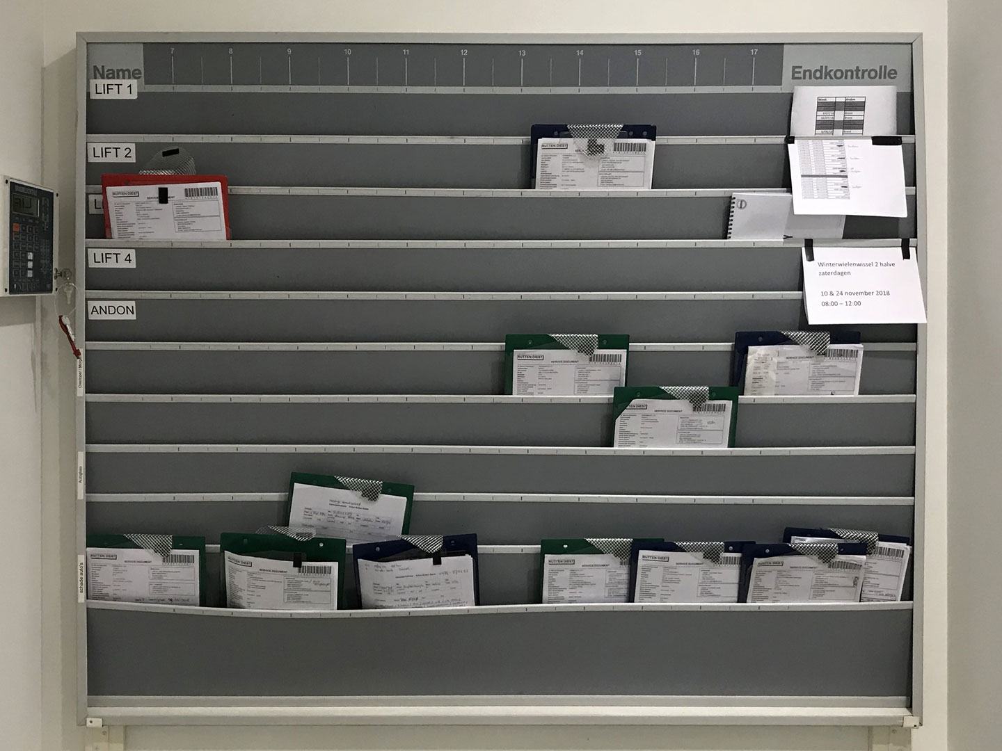 A physical board used to arrange clipboards for vehicle servicing inside a Volvo workshop