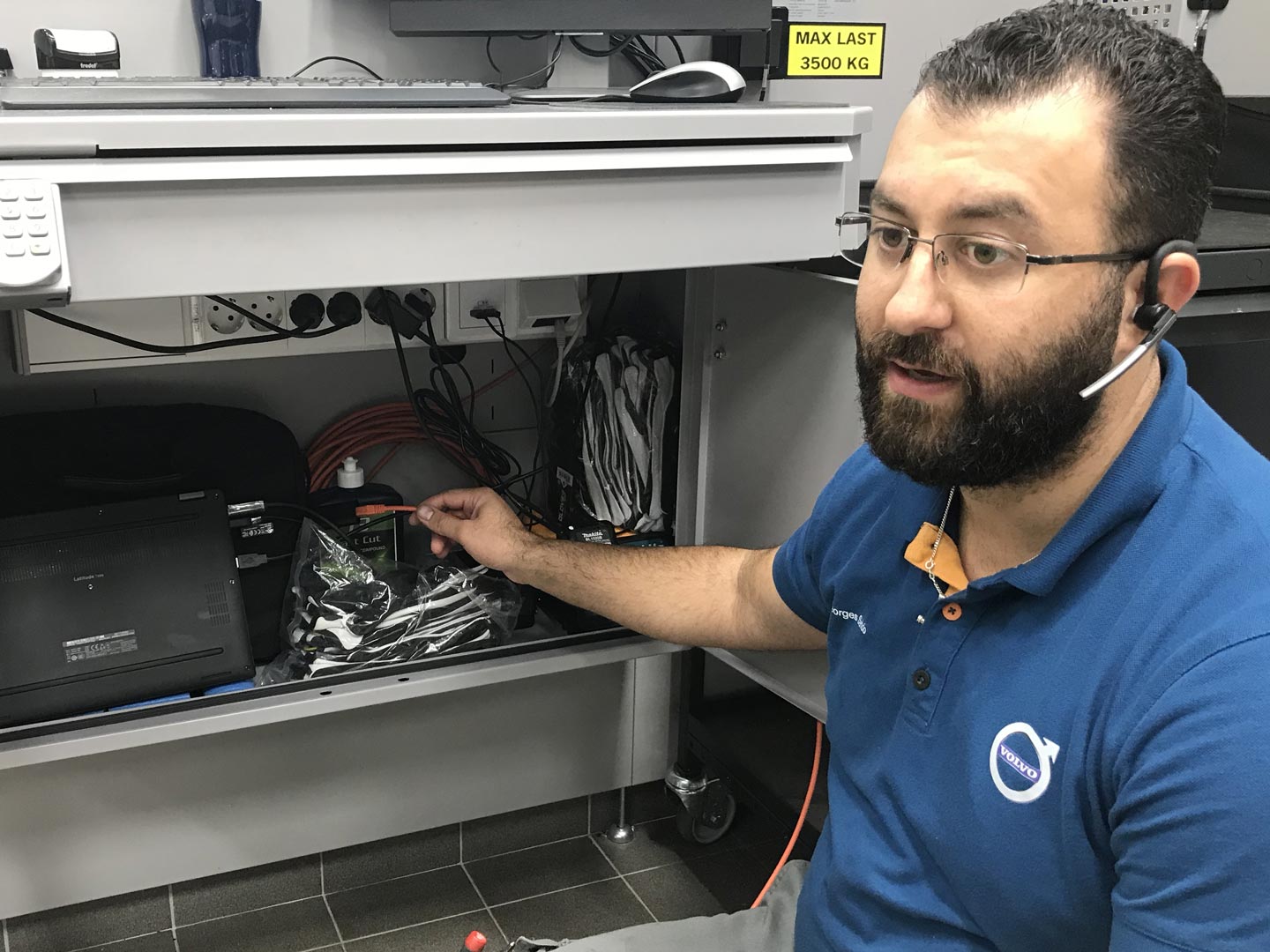 A Volvo technician connects a vehicle to computer equipment